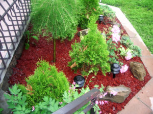 flower patio with red bark rubber mulch